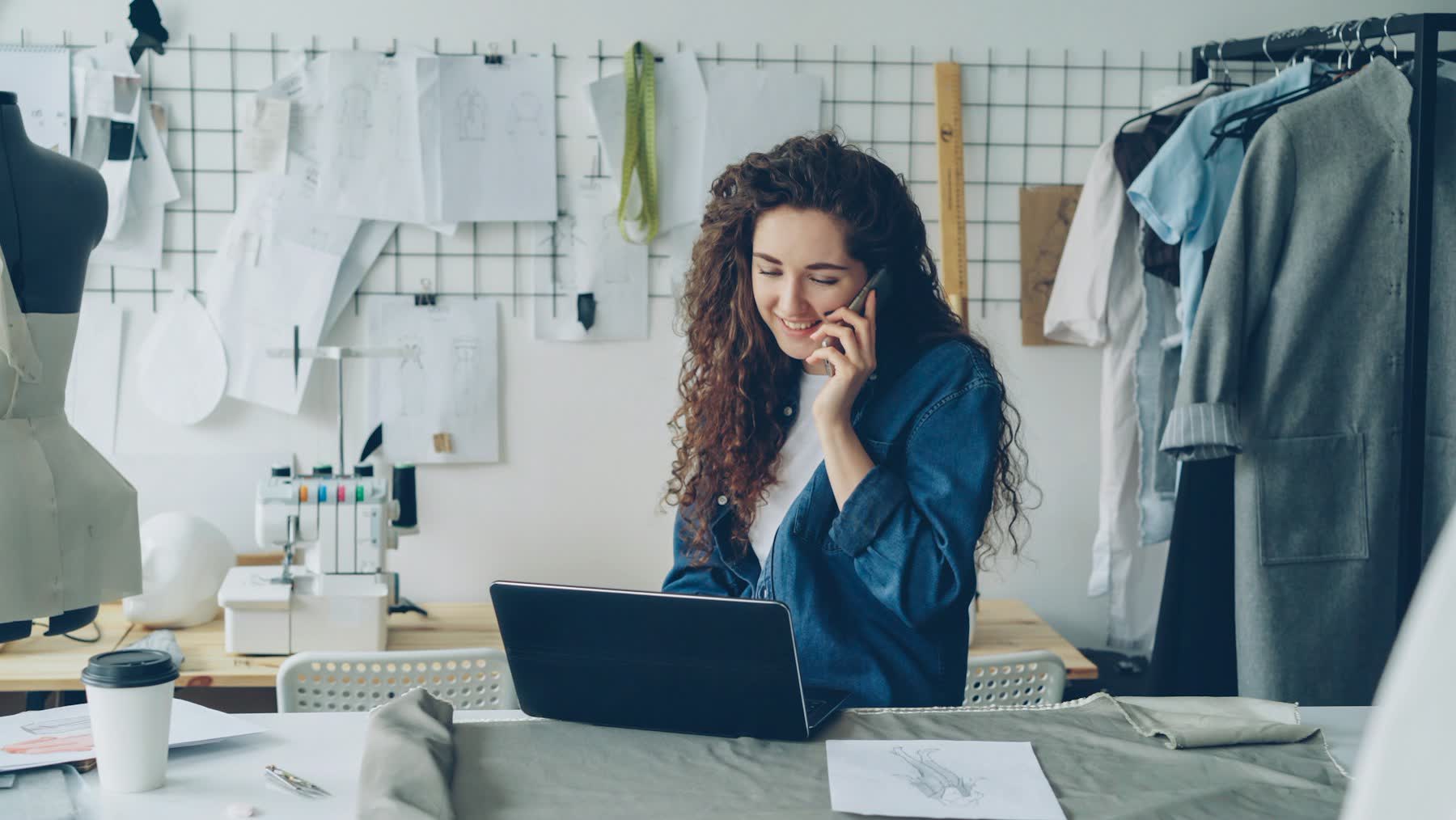 A business owner on the phone at her workbench
